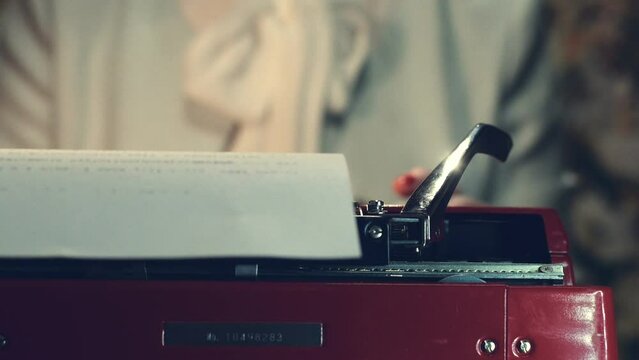 Secretary in retro style and a red vintage typewriter. High quality FullHD footage