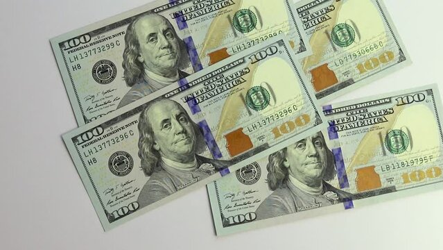 A hundred dollar bills falling down or flying 100 dollar american banknotes. Money rain.