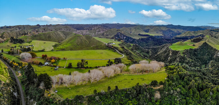 An aerial drone panorama image of a green field farmland in the Mangaweka River Valley on the North Island of New Zealand