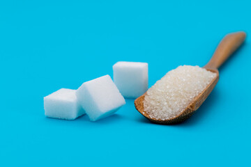 Sugar cubes and sugar crystals in scoop