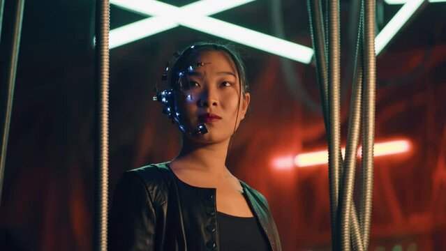 Cyberpunk girl in a black leather jacket and intense facial expressions. Asian girl with one-eyed glasses and headset. Trapped behind black hanging rods. Cyborg, sci-fi, Neon lights.