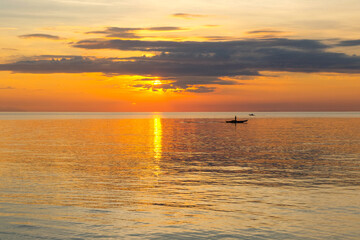 Sunset light on the beach aerial view The sea and the sky at sunset contrast with the sparkling sea.
