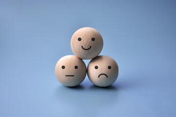 Various emotions: joy, serenity, anger, sadness on wooden circles