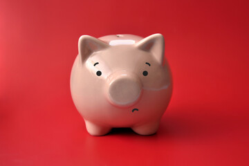 Sad piggy bank. Symbol of bankruptcy