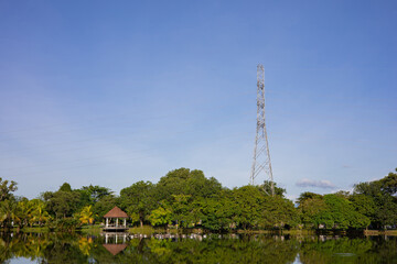 Fototapeta premium High-voltage power poles installed near water sources. clear day