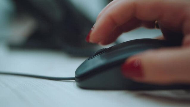 Scroll with a mouse wheel, women's hands with a red manicure will scroll with a mouse