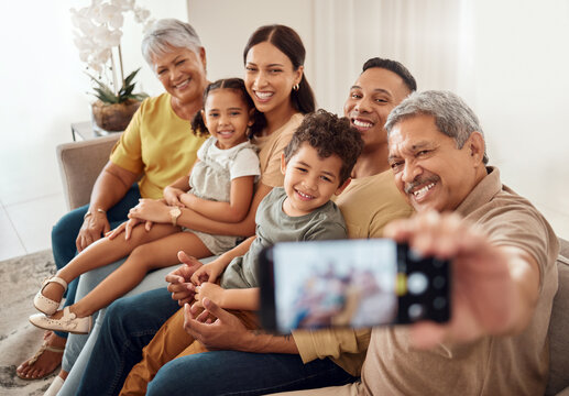 Selfie, family and phone with a senior man taking a photograph with his relatives during a visit in their home. Love, retirement and technology with an elderly male posing for a picture in the house