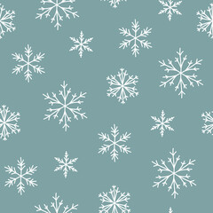 Fototapeta na wymiar Winter seamless pattern with cartoon hand drawn snowflakes on blue background.