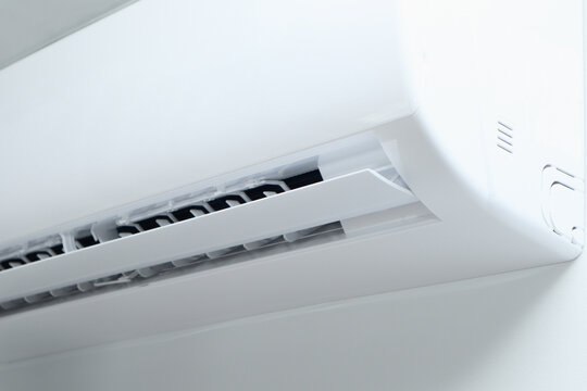 Air conditioner on white wall background. Split air conditioner on a white wall. Closeup image.