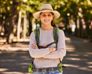 Portrait, hiking and woman in hat arms crossed on holiday, vacation or trip. Travel, freedom and...