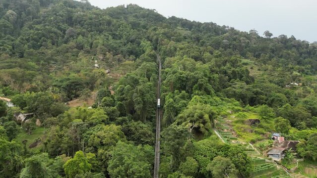 Aerial follow the Penang Hill funicular railway train at the railway ascending