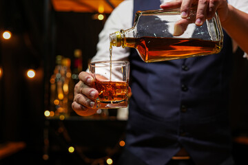 Bartender pouring Whiskey, on  bar,