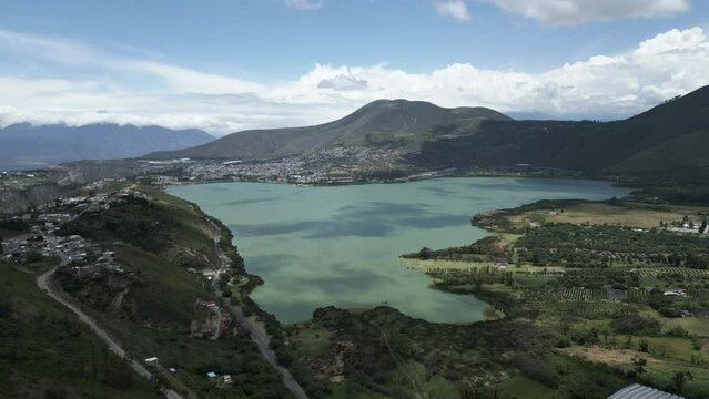 Aerial view flying towards stunning Yahuarcocha Lake in Ibarra, Ecuador