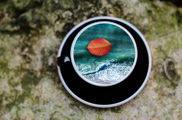 Cup with the sea on a wooden background.