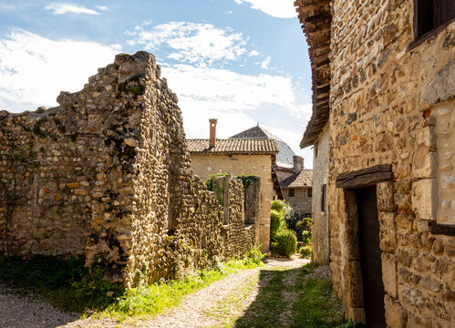 Old medieval street with stone houses, between light and shadow, in the famous village P&eacute;rouges, Ain, Auvergne Rh&ocirc;ne Alpes, France.