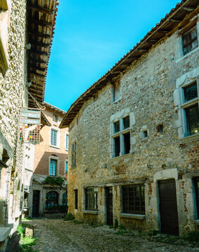 Old medieval street with stone houses, between light and shadow, in the famous village P&eacute;rouges, Ain, Auvergne Rh&ocirc;ne Alpes, France.