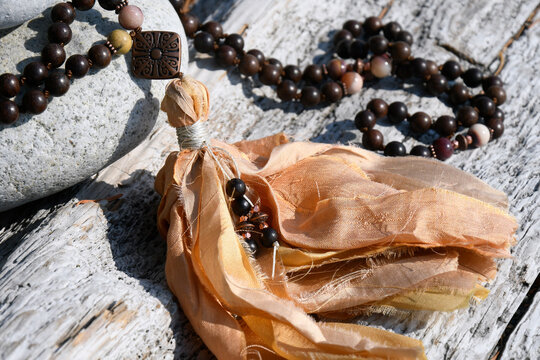 A close up image of the tassels on a mala bead meditation necklace.  
