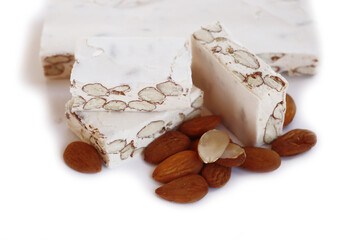 Traditional italian festive Torrone di Cremona ( white Nougat) with almonds cut in pieces isolated on white background