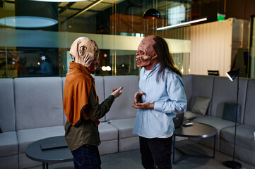 Zombie coworkers speaking together in office