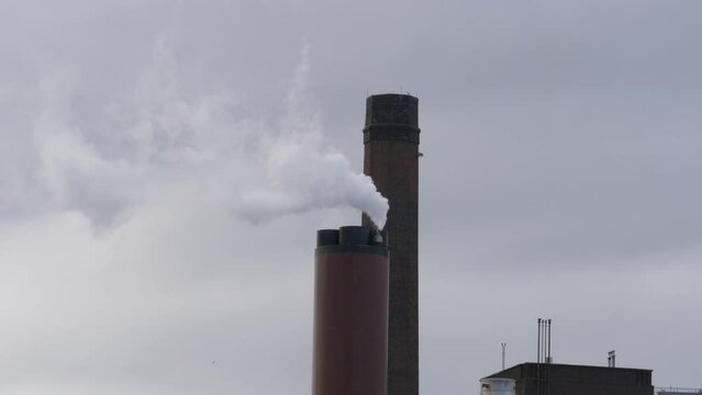 Guinness Brewery Chimney Emitting Smoke In The Air In Dublin, Ireland. - close up