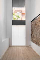 Refurbished apartment with restored ancient wall left from old city buildings.