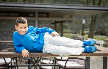 boy laying on a bench