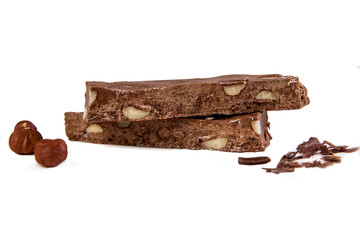 Handmade chocolate slice with hazelnuts. Sweets and pleasure in food. Close-up. Isolated on white background.