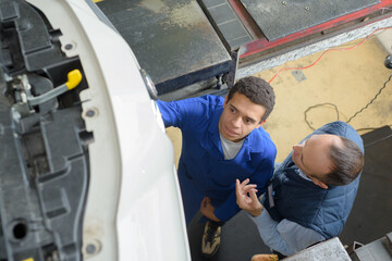 two mechanic repairing a car