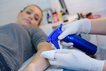 she is spraying the skin