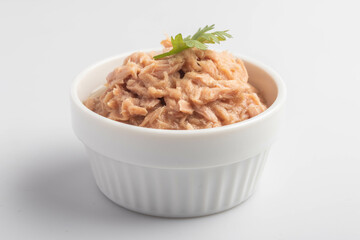 canned tuna in a white cup on a white background