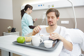 nurse and young man in hospital
