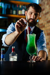 Close up of barman decorate blue lagoon cocktail