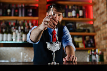 Barman preparing cocktail in night club