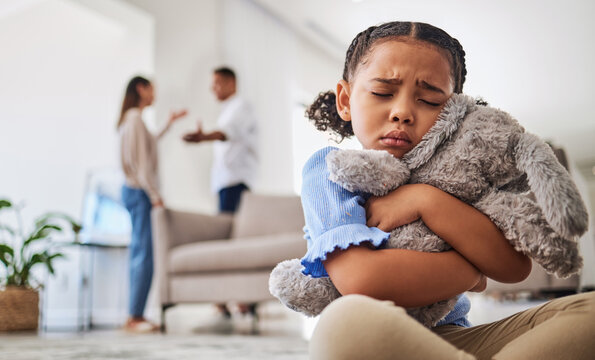 Parents fight, sad girl and teddy hug of a child crying from divorce in a home living room. Depressed kid, problem and youth anxiety of children depression from mama and dad family fighting