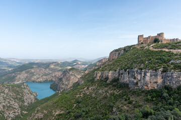 Fototapeta na wymiar Beautiful landscape photo of mountains and trees where you can see the Chirel castle and the Cortes del Pallas reservoir, Valencian community, Spain