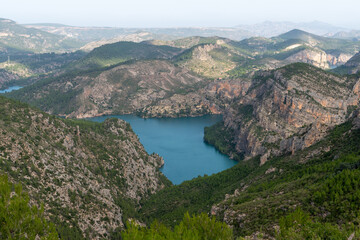 Fototapeta na wymiar Beautiful landscape photo with the mountains surrounding the reservoir of cortes del pallas, Valencian community, Spain