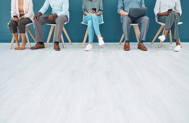 Fototapeta na wymiar Business people, legs and job interview wait on technology in studio, startup company or digital marketing office. Men, women and workers line in human resources, global recruitment or hr tech review