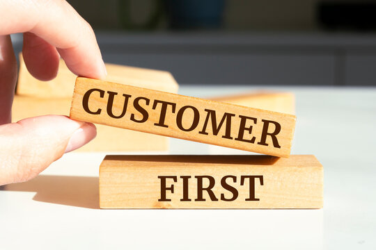 Wooden blocks with words 'Customer First'.
