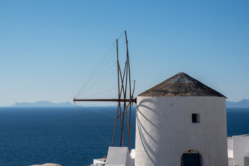 Windmill at oia with Blue sea in background - 539651536