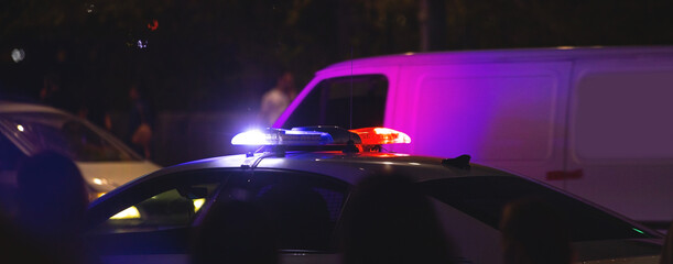 Red and blue light flasher. Police car at night time in the city
