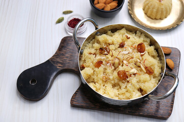 Rava Sheera or Suji ka halwa, shira is an indian sweet dish, made with semolina, sugar, ghee and dry fruits. served as dessert or as Prasad during festivals. Garnished with saffron. Copy space.