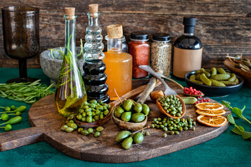 Capers in spoon and bowl on the table