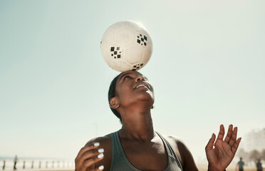 Head balance, sports and soccer ball with woman athlete in the sun and nature. Fitness, balancing...