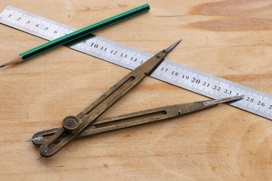 Old bronze divider for carpentry. Old carpentry's compass. Carpentry's tool.