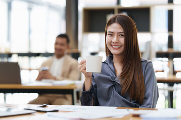 Businesswoman using calculator and laptop for do math finance on wooden desk in office and business working background, tax, accounting, statistics and analytic research concept