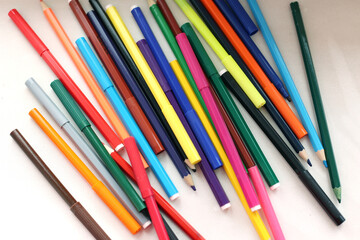 Set of colored pencils and felt-tip pens, preparation for school, many different pencils on white background, close-up
