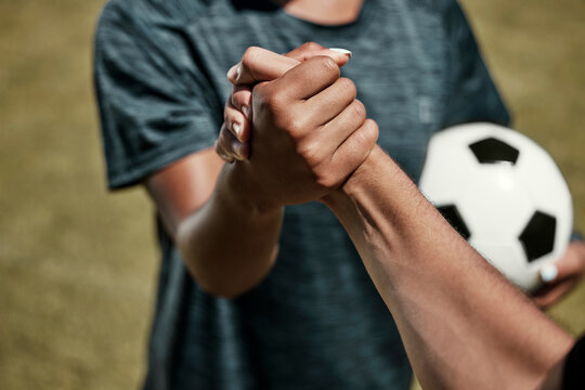 Soccer, football and team handshake on field before start of match, game or competition. Teamwork, collaboration and soccer players shaking hands before exercise, workout or training on grass field.