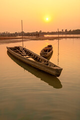 Two beautiful small boats at sunset in .fishing village