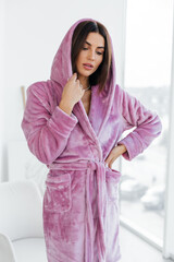 Young healthy serene woman girl relaxing in bathrobe and spa towel after having bath shower at...