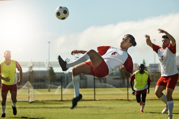 Soccer team, man and ball kick in air during football match, competition or training. Sports,...